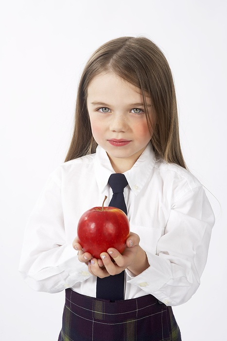 Girl in School Uniform Holding Apple, by Edward Pond / Design Pics