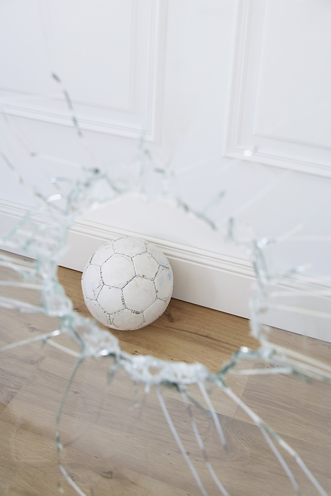 Soccer Ball and Broken Window, by photo division / Design Pics