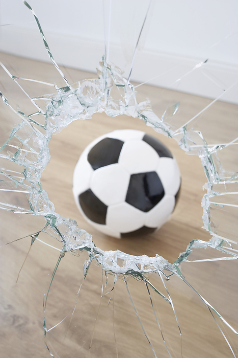 Soccer Ball and Broken Window, by photo division / Design Pics