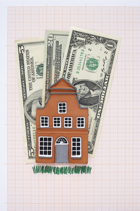 House and American Currency on Graph Paper, by photo division / Design Pics
