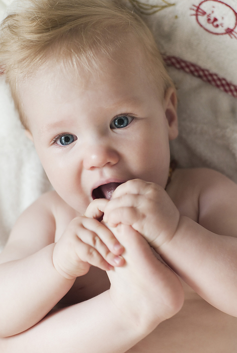 Baby Girl with Toes in Mouth, by I. Jonsson / Design Pics