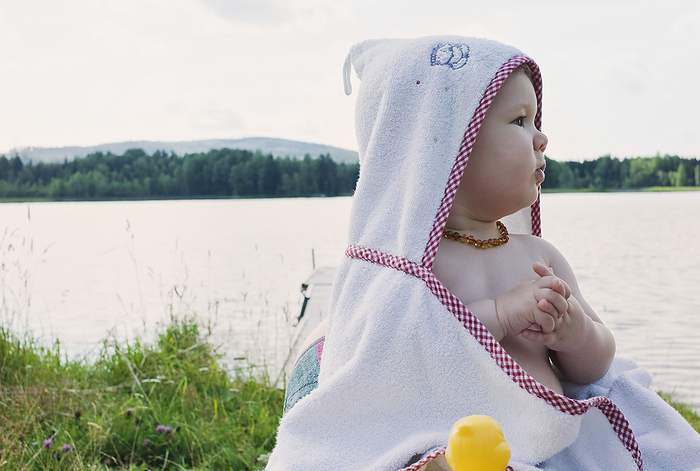 Baby Girl in Towel by Lake, by I. Jonsson / Design Pics