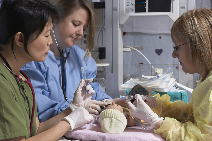 Nurses Practicing on Baby Mannequin, by Michael Mahovlich / Design Pics