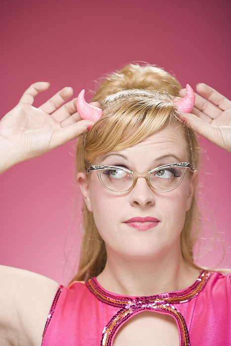 Portrait of Woman Wearing Devil Horns and Vintage Eyeglasses, by Mitch Tobias / Design Pics