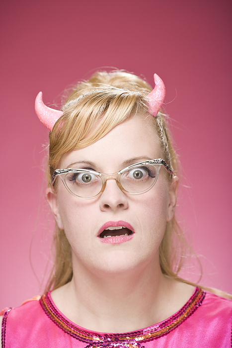 Portrait of Woman Wearing Devil Horns and Vintage Eyeglasses, by Mitch Tobias / Design Pics
