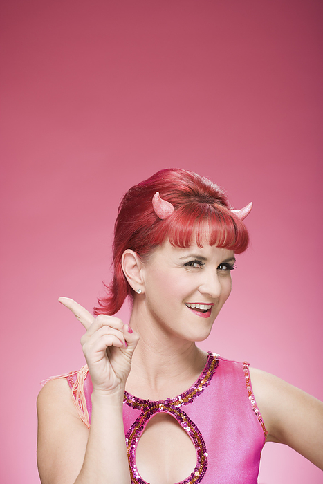 Portrait of Woman Wearing Devil Horns Wagging Finger, by Mitch Tobias / Design Pics