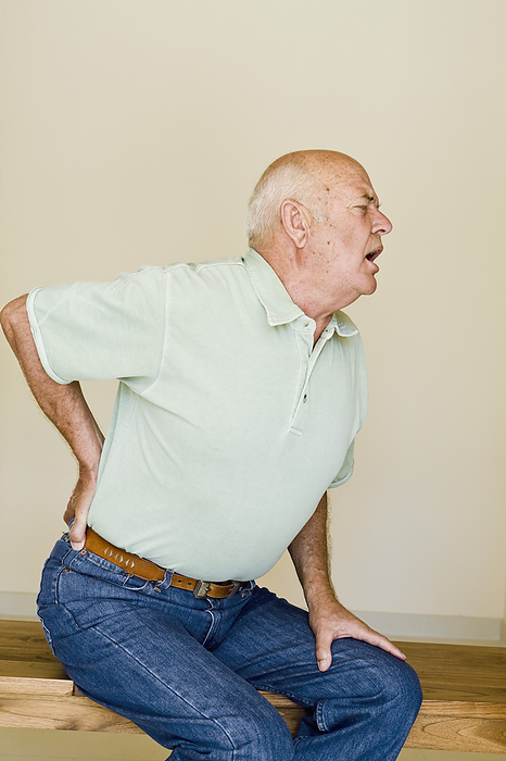 Man with Back Pain, by Norbert Schäfer / Design Pics