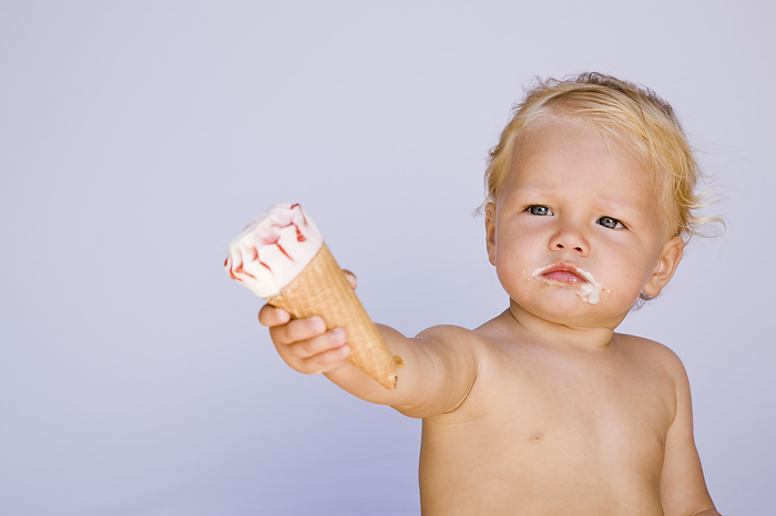 Baby Offering Ice Cream Cone, by Norbert Schäfer / Design Pics