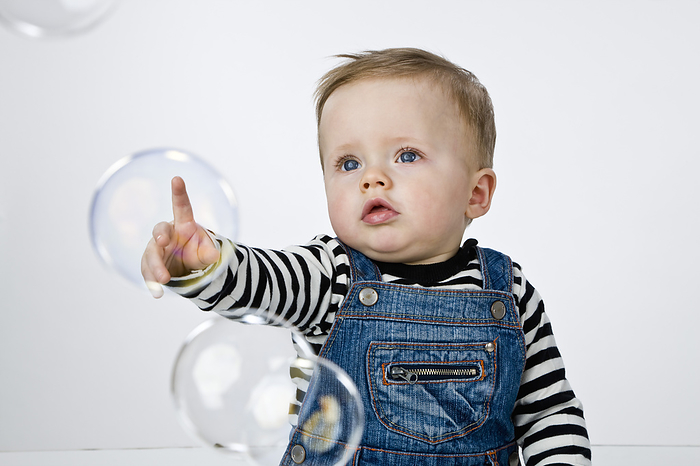 Baby Boy Poking Bubbles, by Norbert Schäfer / Design Pics