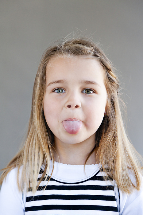 Portrait of Girl Sticking Tongue Out, by Norbert Schäfer / Design Pics