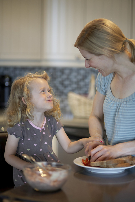 Mother and Daughter Preparing Food in Kitchen, by Sarah Murray / Design Pics