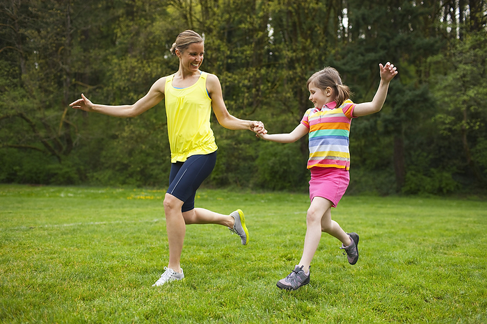 Mother and Young Daughter Exercising in the Park, Portland, Oregon, USA, by Ty Milford / Design Pics