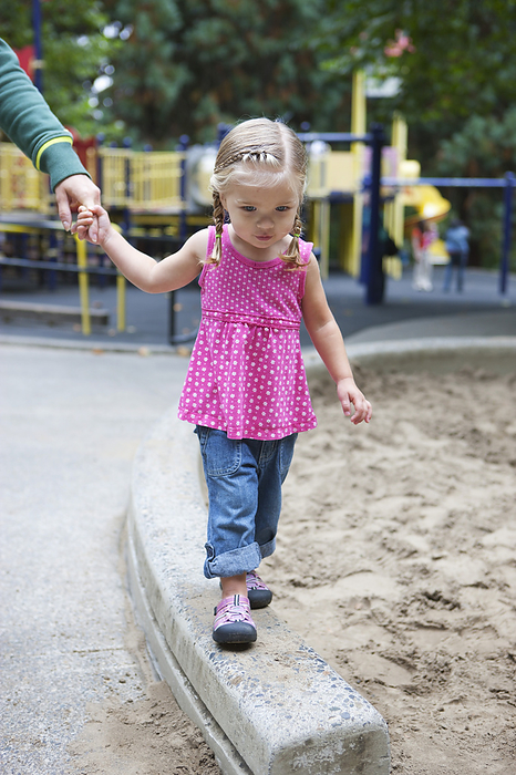 Girl Holding Mom's Hand, Washington Park Playground, Portland, Oregon, USA, by Ty Milford / Design Pics