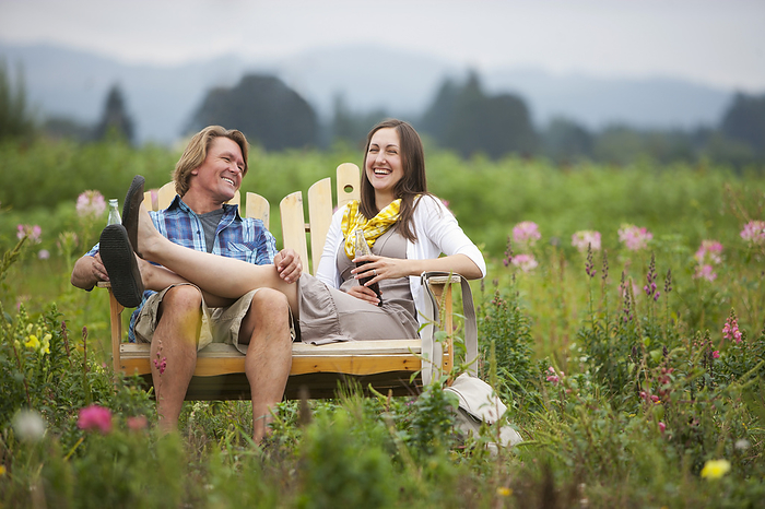 Couple on Bench in Field, Portland, Oregon, USA, by Ty Milford / Design Pics