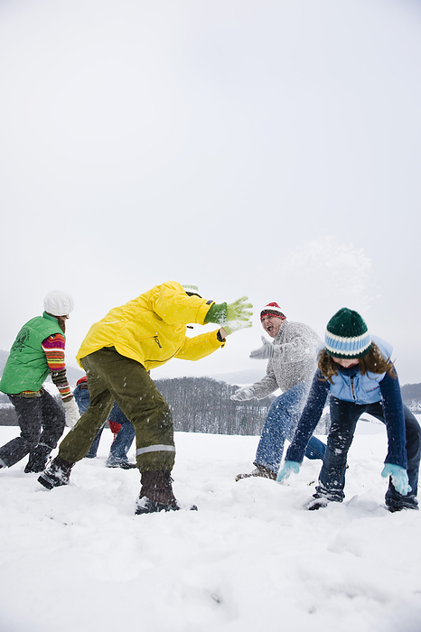 Family Having Snowball Fight, by Uwe Umstätter / Design Pics