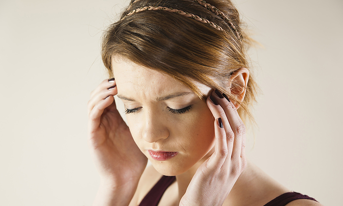 Head and shoulders portrait of teenage girl with hands on her head in studio., by Uwe Umstätter / Design Pics