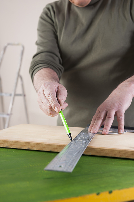 Man Measuring Lumber, Woodworking Project, in Studio, by Uwe Umstätter / Design Pics