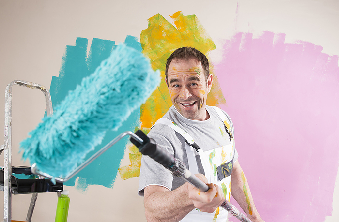 Portrait of Mature Man with Paint Roller Renovating his Home, by Uwe Umstätter / Design Pics