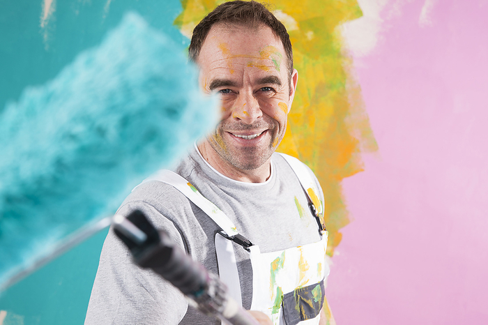 Portrait of Mature Man with Paint Roller Renovating his Home, by Uwe Umstätter / Design Pics