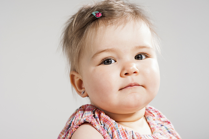 Head and Shoulders Portrait of Baby Girl, Studio Shot, by Uwe Umstätter / Design Pics