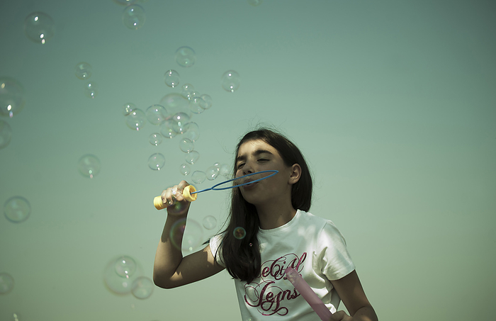 Girl Blowing Bubbles, Mannheim, Baden-Wurttemberg, Germany, by Uwe Umstätter / Design Pics