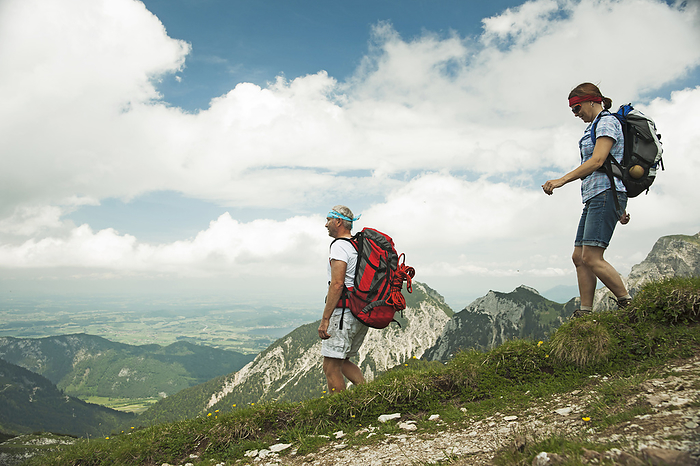 Mature couple hiking in mountains, Tannheim Valley, Austria, by Uwe Umstätter / Design Pics