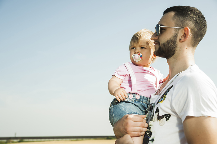 Father Holding Baby Daughter Outdoors, Mannheim, Baden-Wurttemberg, Germany, by Uwe Umstätter / Design Pics