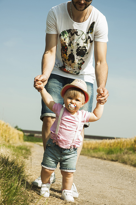 Father and Baby Daughter Walking Outdoors, Mannheim, Baden-Wurttemberg, Germany, by Uwe Umstätter / Design Pics