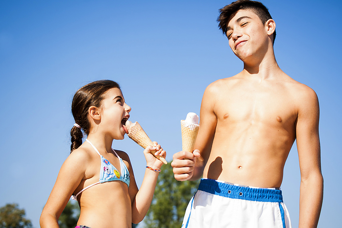 Boy and Girl eating Ice Cream Cones, Lampertheim, Hesse, Germany, by Uwe Umstätter / Design Pics