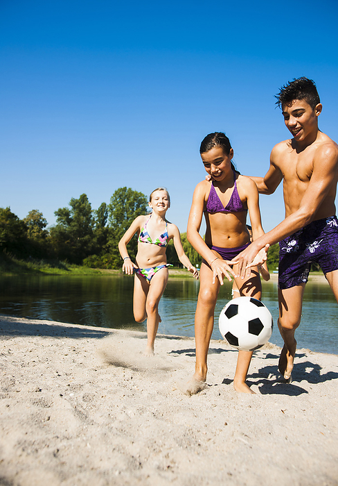 Kids Playing Soccer on Beach by Lake, Lampertheim, Hesse, Germany, by Uwe Umstätter / Design Pics