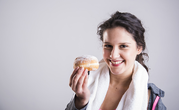 Portrait of Teenager with Doughnut, by Uwe Umstätter / Design Pics