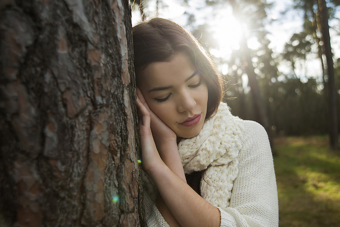 Young Woman Leaning against Tree Trunk, Mannheim, Baden-Wurttemberg, Germany, by Uwe Umstätter / Design Pics