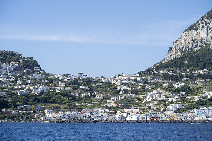 Capri, Italy View from the Tyrrhenian Sea looking towards the shore at Capri Town on a plateau like a saddle high above the sea with the island s port, Marina Grande below  Naples, Capri, Italy, by Chris Caldicott   Design Pics