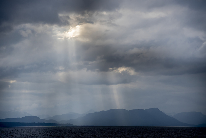 America Sunlight breaking through rain clouds in Chatham Strait, in Southeast Alaska  Alaska, United States of America, by Karen Kasmauski   Design Pics
