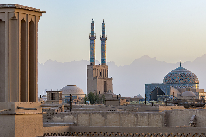 Yazd, Iran Overview of Jamesh Mosque of Yazd at sunset with the soft silhouette of the Zagros Mountain in the distance  Yazd City, Yazd Province, Iran, by Christopher Roche   Design Pics