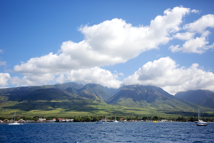 Maui, Hawaii Boats moored off shore in the Lahaina Harbor with the West Maui Mountains in the background viewed from the water  Lahaina, Maui, Hawaii, United States of America, by Ron Dahlquist   Design Pics