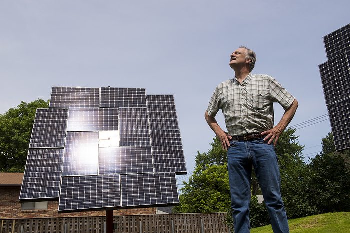 Man standing near his solar panels; Lincoln, Nebraska, United States of America, by Joel Sartore Photography / Design Pics