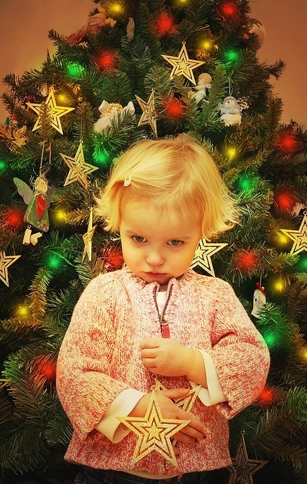 Child Pouts In Front Of Christmas Tree, by Don Hammond / Design Pics