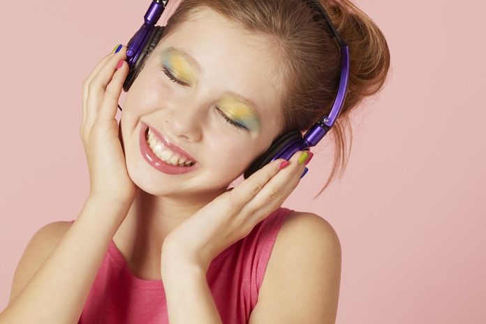 Woman listening to music Girl in colorful makeup and headphones