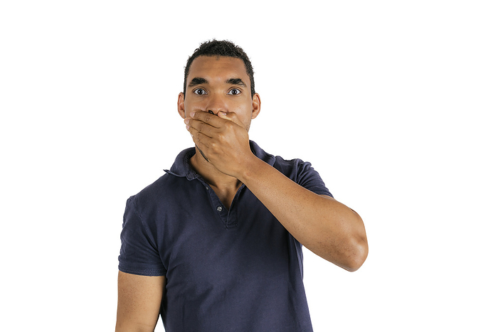 Man covering mouth with hand against white background