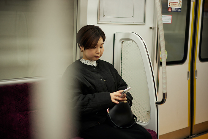 Young Japanese woman riding the subway