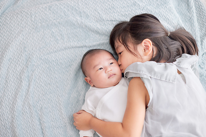 Japanese girl cuddling with her baby