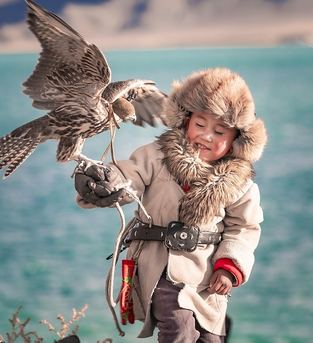 Mongolian falcon hunter, little boy with trained falcon, province Bajan-Ölgii, Mongolia, Asia, by Bayar Balgantseren