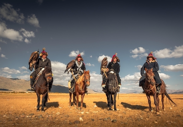 Mongolian eagle hunters, four Kazakhs with trained eagles on horses in the Mongolian steppe, Bayan-Ölgii Province, Mongolia, Asia, by Bayar Balgantseren