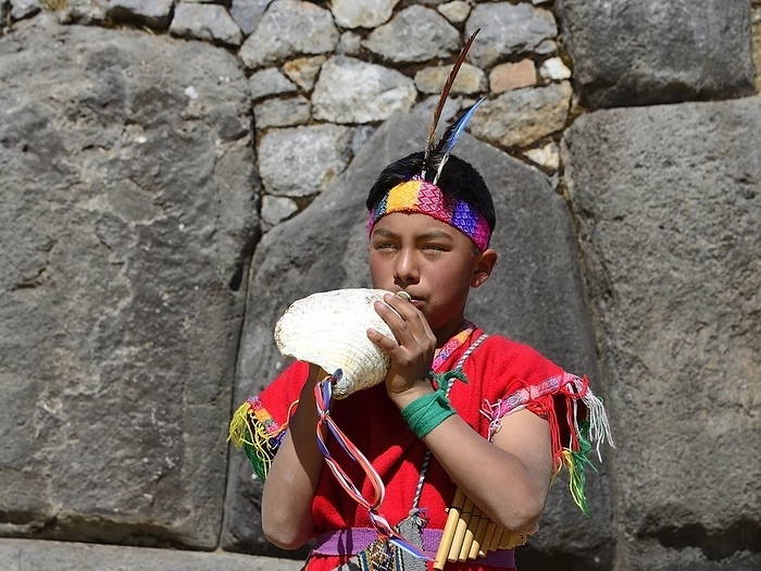 Inti Raymi, festival of the sun, young indigenous man blowing the conch shell, ruins of the Inca Sacsayhuamán, Cusco, Peru, South America, by Peter Giovannini