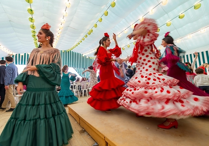 Young woman dancing Sevillano, Spanish woman with flamenco dresses in colourful marquee, Casetas, Feria de Abril, Sevilla, Andalusia, Spain, Europe, by Mara Brandl
