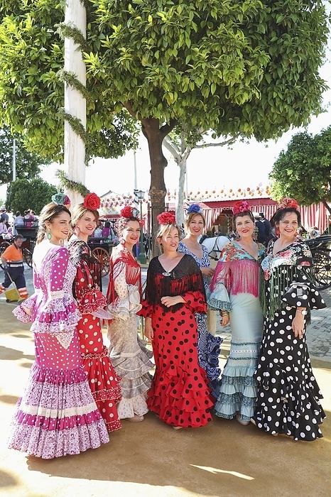 Women, frilled dresses, Feria de Abril, folk festival, tents, flamenco dress, flamenco dance, Seville, Andalucia, Spain, Europe, by Clara Montes