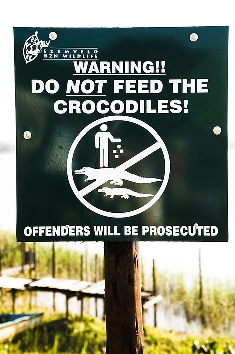 Warning sign, Crocodile feeding ban, Lake St Lucia, iSimangaliso Wetland Park, South Africa, St Lucia, Africa, by Raimund Franken