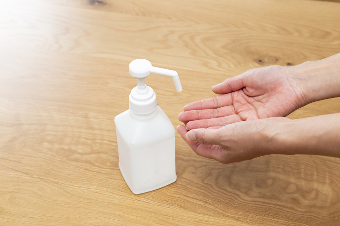 Woman's hand disinfecting with alcohol
