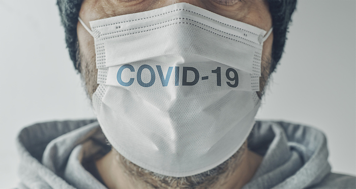 Man wearing COVID 19 mask Man wearing a COVID 19 mask., by IGOR STEVANOVIC   SCIENCE PHOTO LIBRARY